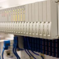 Programmable logic controller PLC modules installed in a rack. Selective focus.